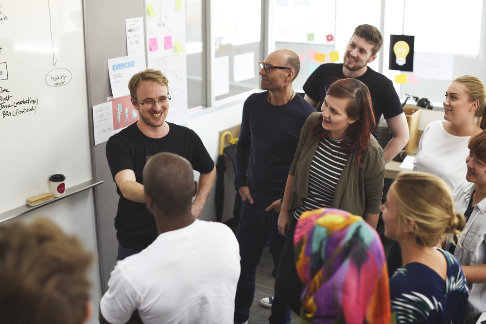 Modern office collaboration space with team working together at a large table