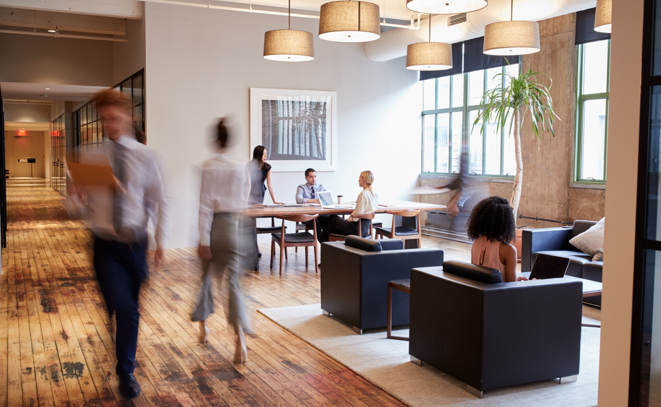 What to Expect During Your First Time at a Coworking Space Businesspeople at work in a busy luxury office space