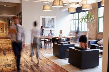 Businesspeople at work in a busy luxury office space