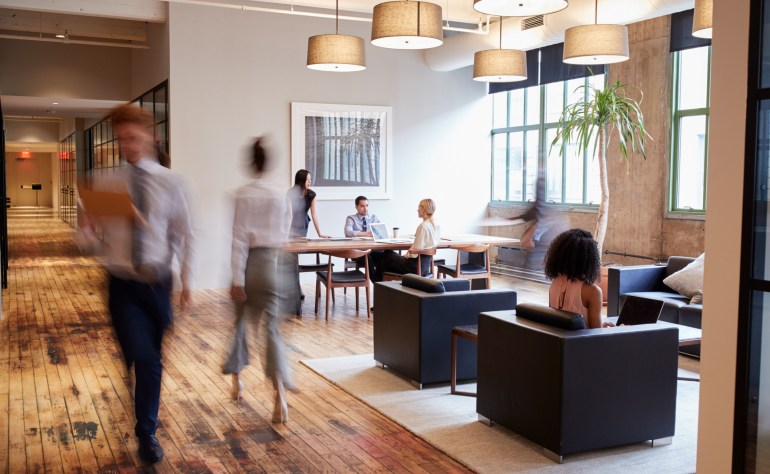 Businesspeople at work in a busy luxury office space