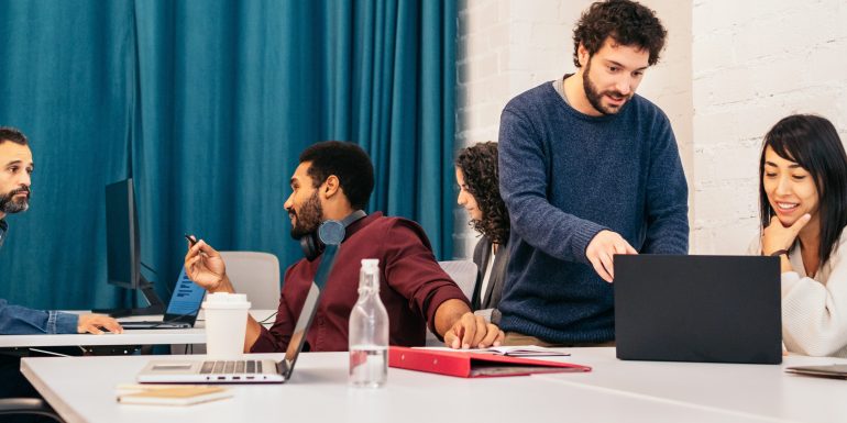 How to Network in a Remote World: Practical Strategies That Go Beyond LinkedIn Group of people of different races working concentrated and happy with laptops in a coworking office