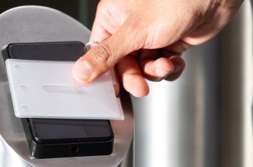 Scanning access card, person entering secure office building for work. Security, identification, workplace, technology, corporate, entry