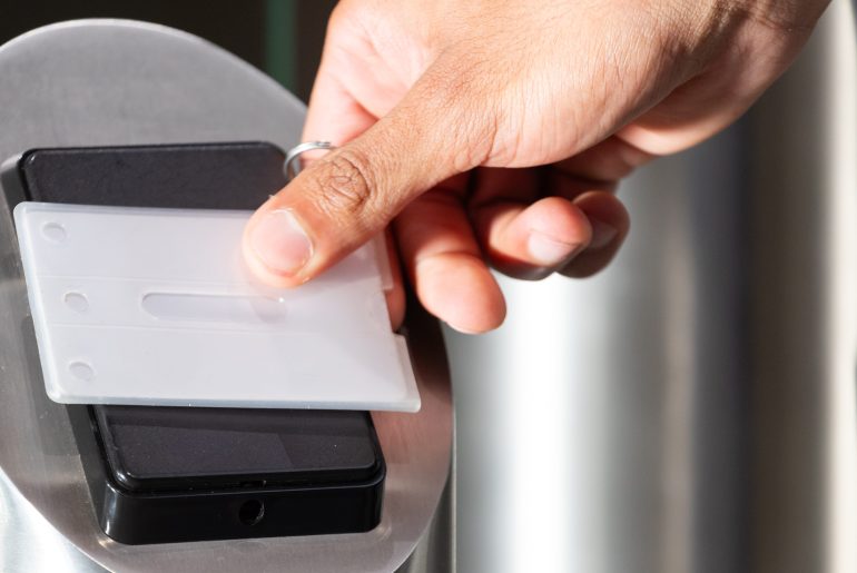 Scanning access card, person entering secure office building for work. Security, identification, workplace, technology, corporate, entry