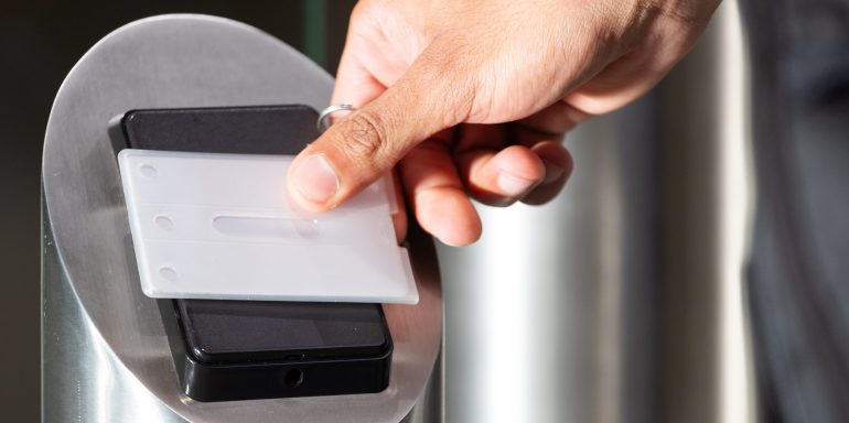 Scanning access card, person entering secure office building for work. Security, identification, workplace, technology, corporate, entry
