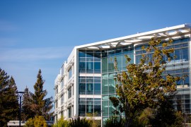 glass office building with a few trees surrounding it