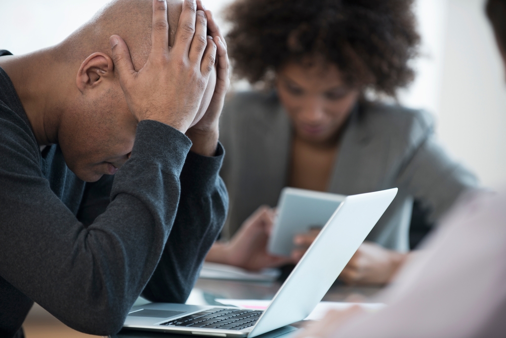 Frustrated businessman using laptop