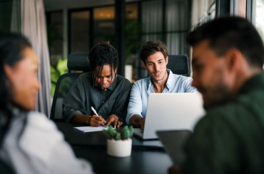 four people working at a table