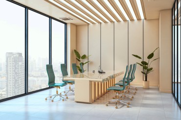 meeting room, with a cream table and walls, large windows, and turquoise office chairs surrounding the table