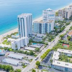 Aerial view of Southern Florida city, which includes a few tall office buildings near the seaside.