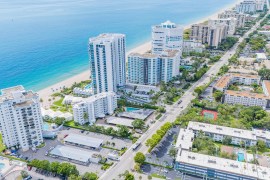 Aerial view of Southern Florida city, which includes a few tall office buildings near the seaside.